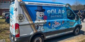 Police van with graphics for the Sheriff’s Community Outreach Programs and Education featuring a cartoon polar bear in a hat holding an ice cream cone, labeled 'Polar Patrol' promoting ice cream and community engagement.