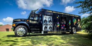 Black sheriff's vehicle labeled 'S.C.O.P.E. Sheriff's Community Outreach Programs & Education' with large speaker graphics and colorful musical notes on the side, parked on grass under a partly cloudy sky.
